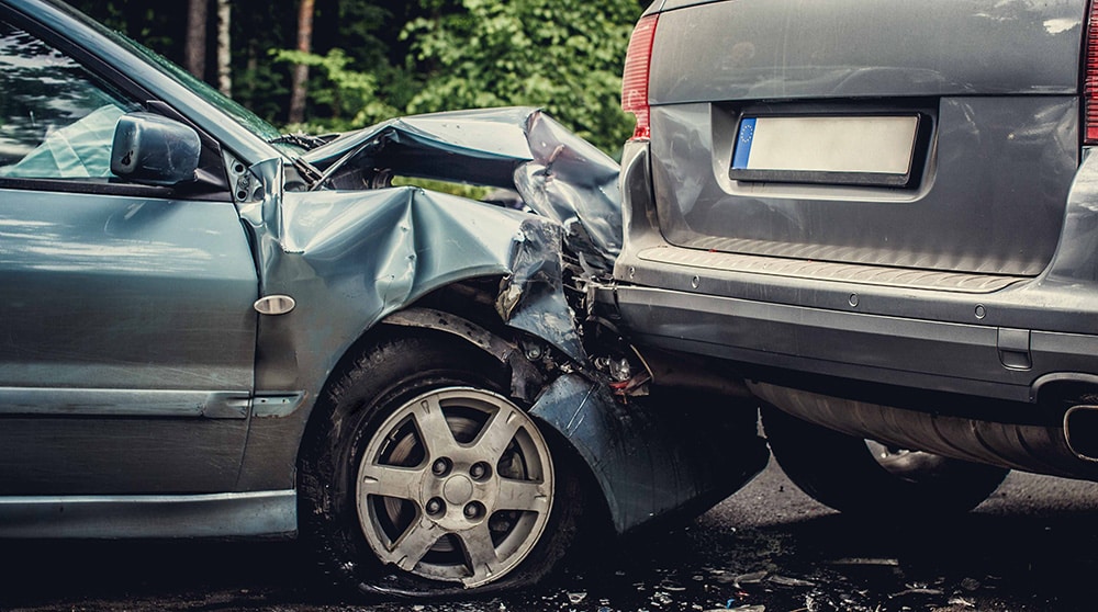 Close up smached cars on a road.